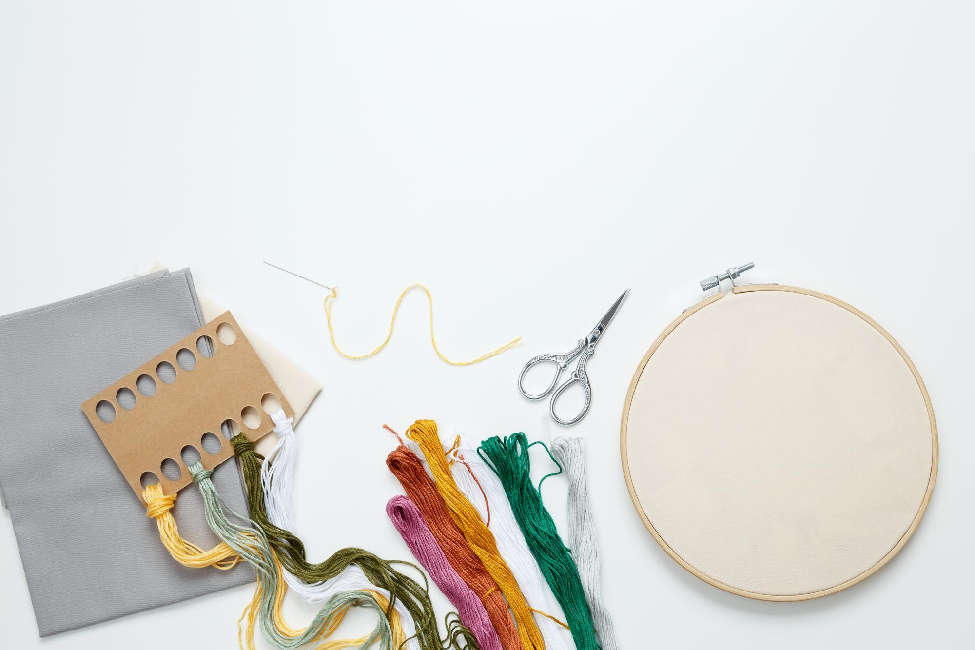 Flatlay of embroidered samples and tools